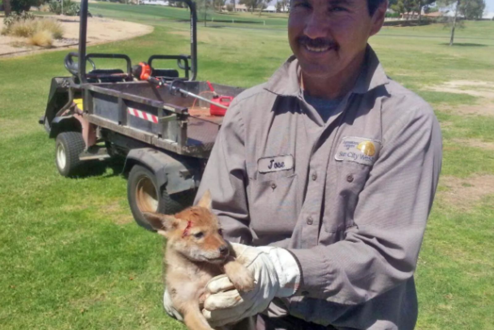 guy holding a coyote