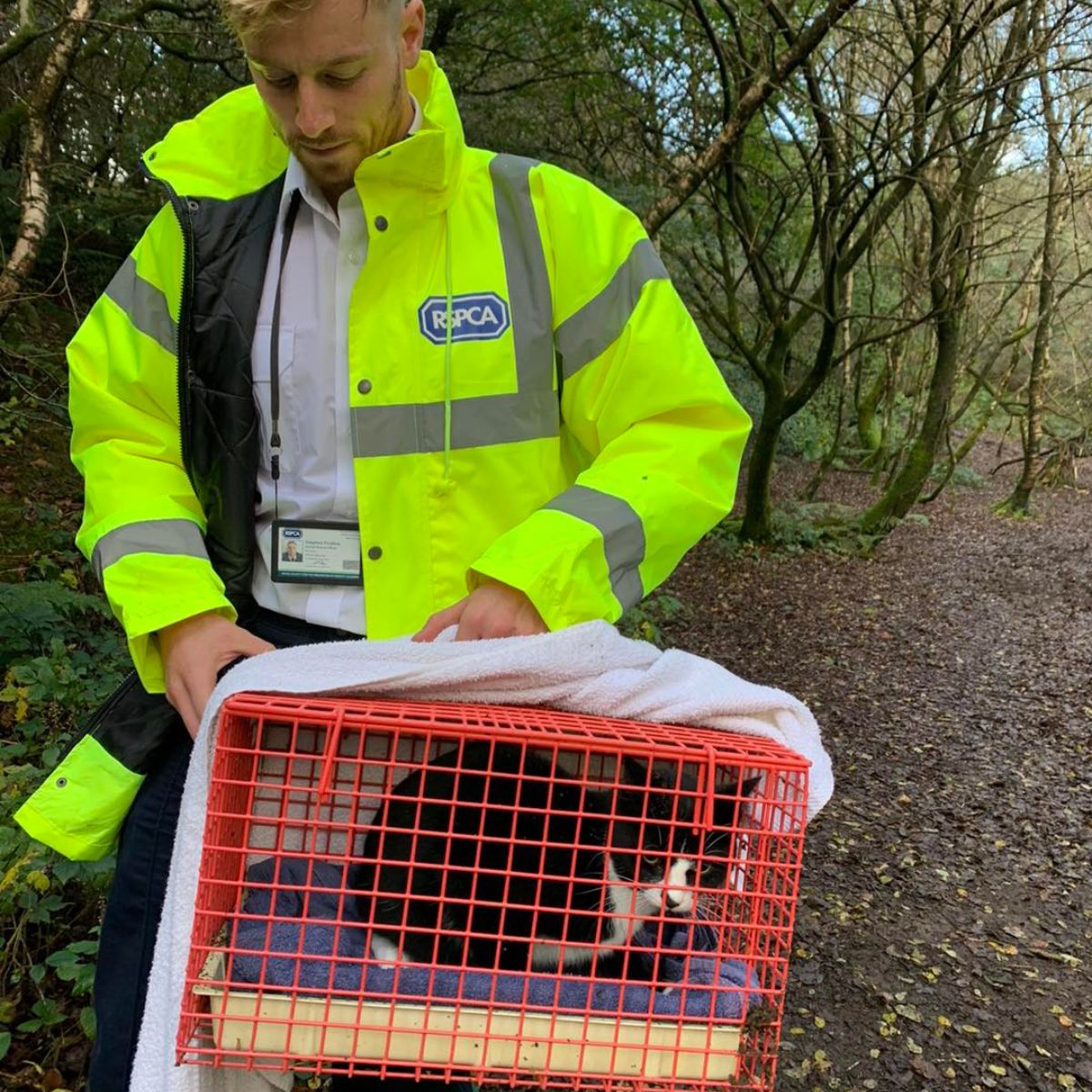 guy holding a cage with cat