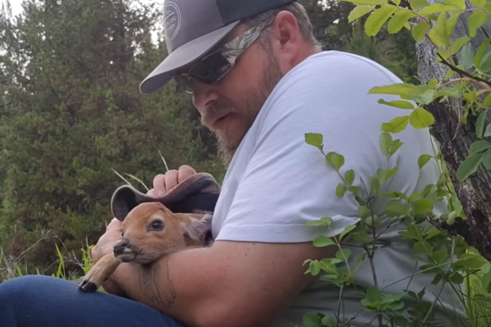 man holding a fawn in the blanket