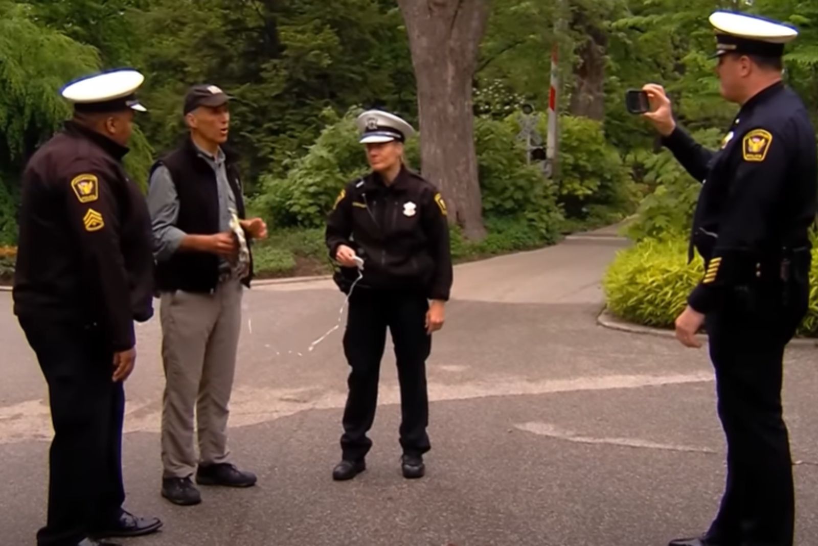 police offcier recording man in a zoo