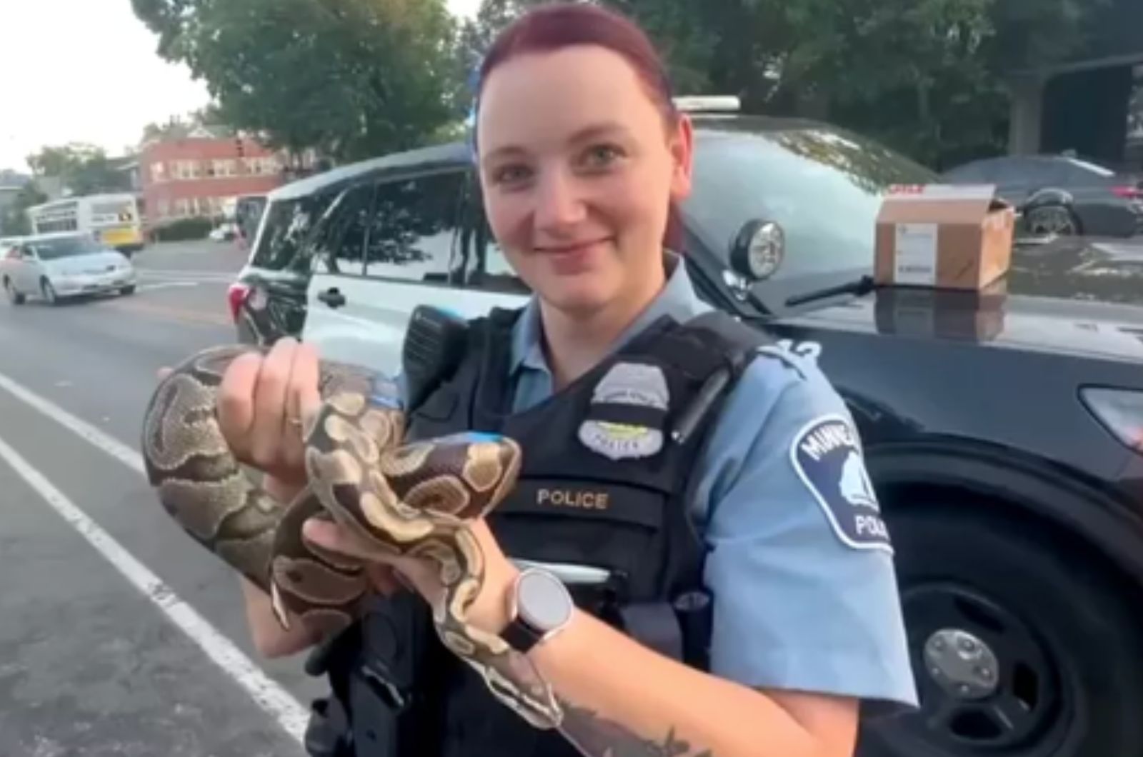 police officer posing with snake