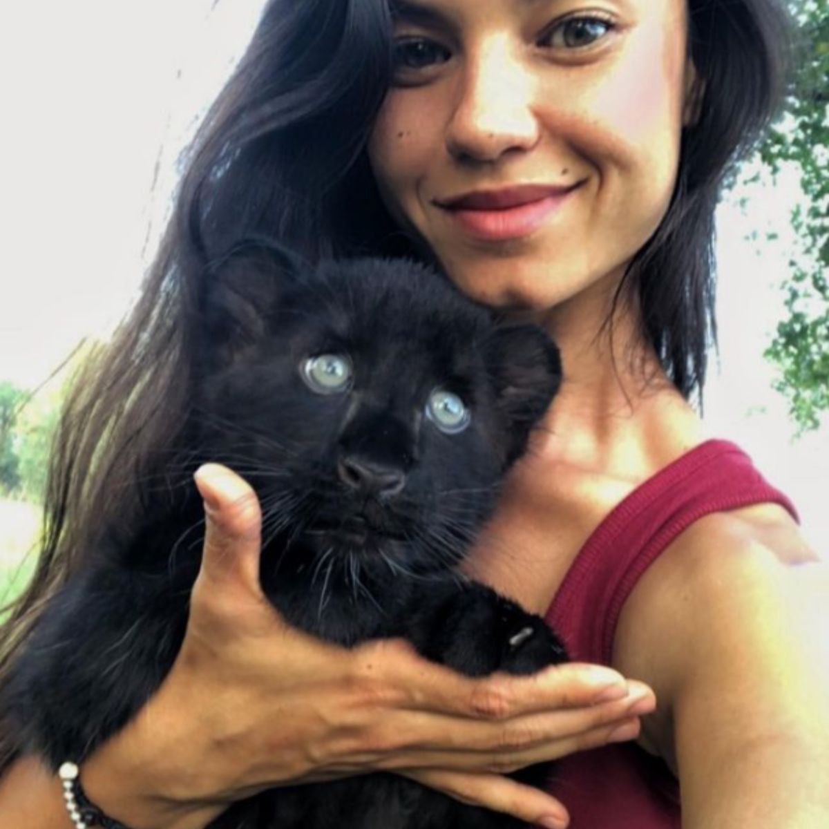 woman holding baby panther