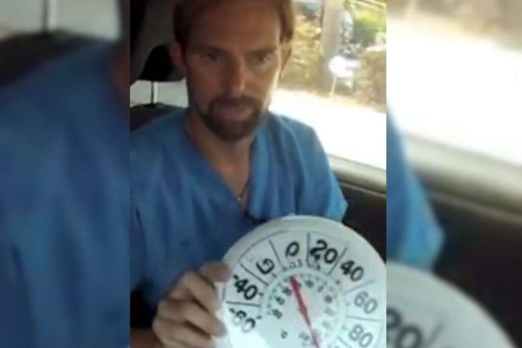 a man is sitting in a car and holding a device in his hand