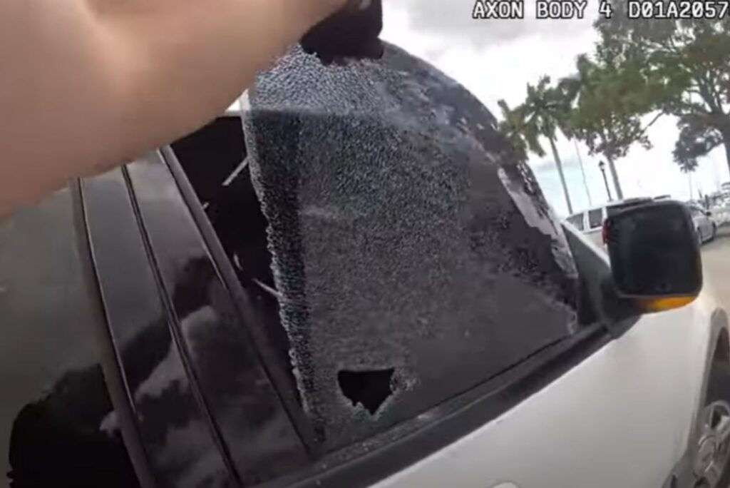 a man rolls off a car window