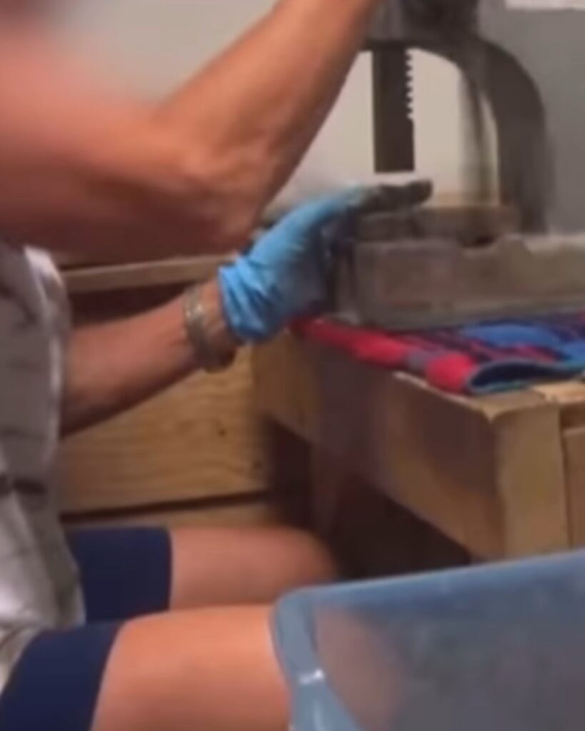 a woman sits at a woodworking machine