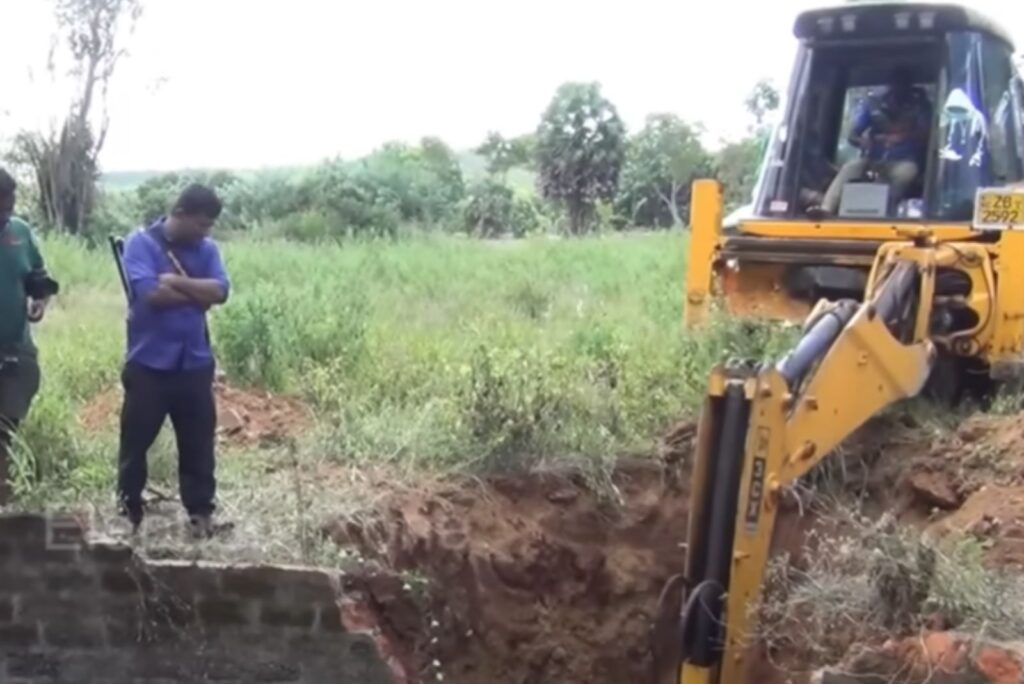 an excavator digs a well