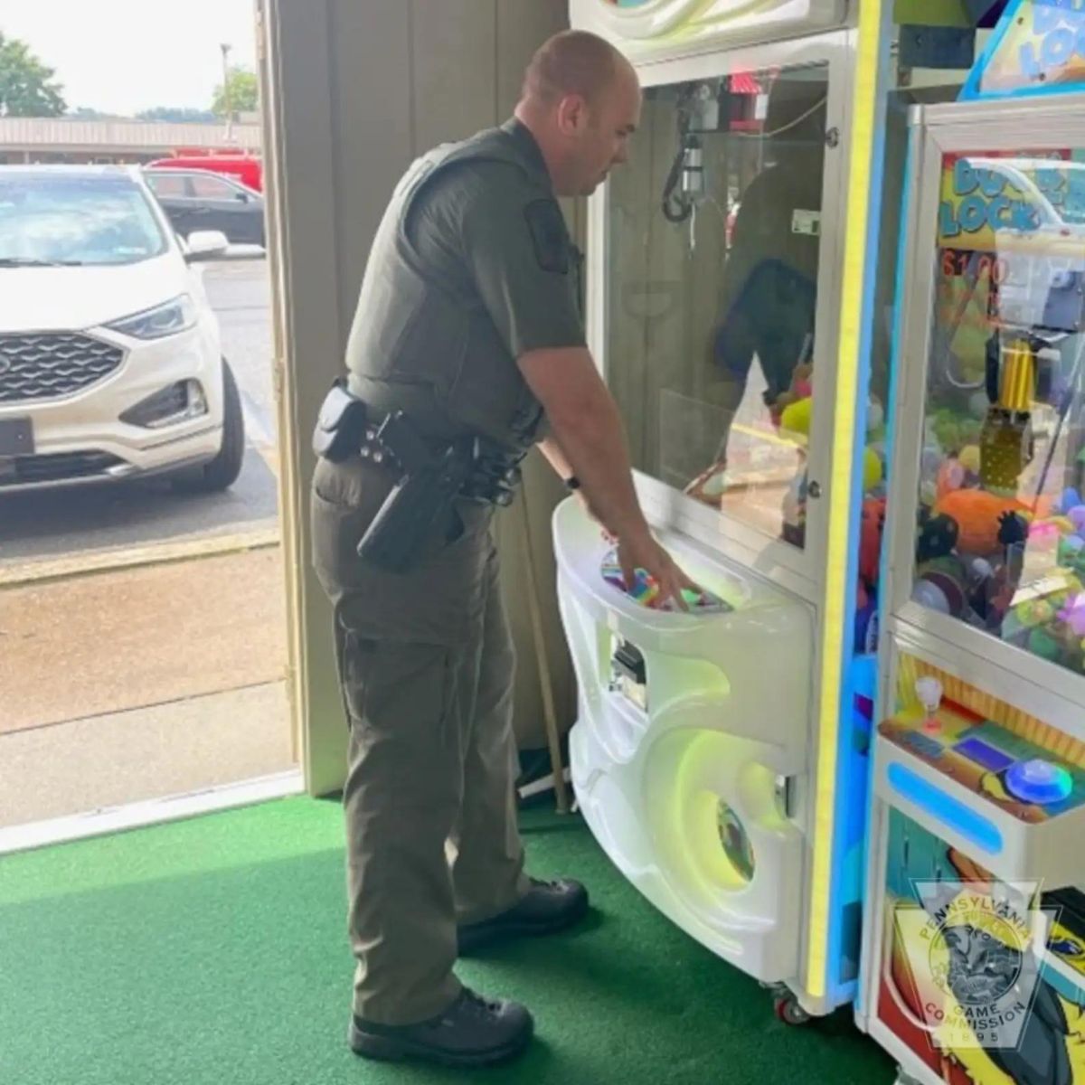 man standing in front of claw machine