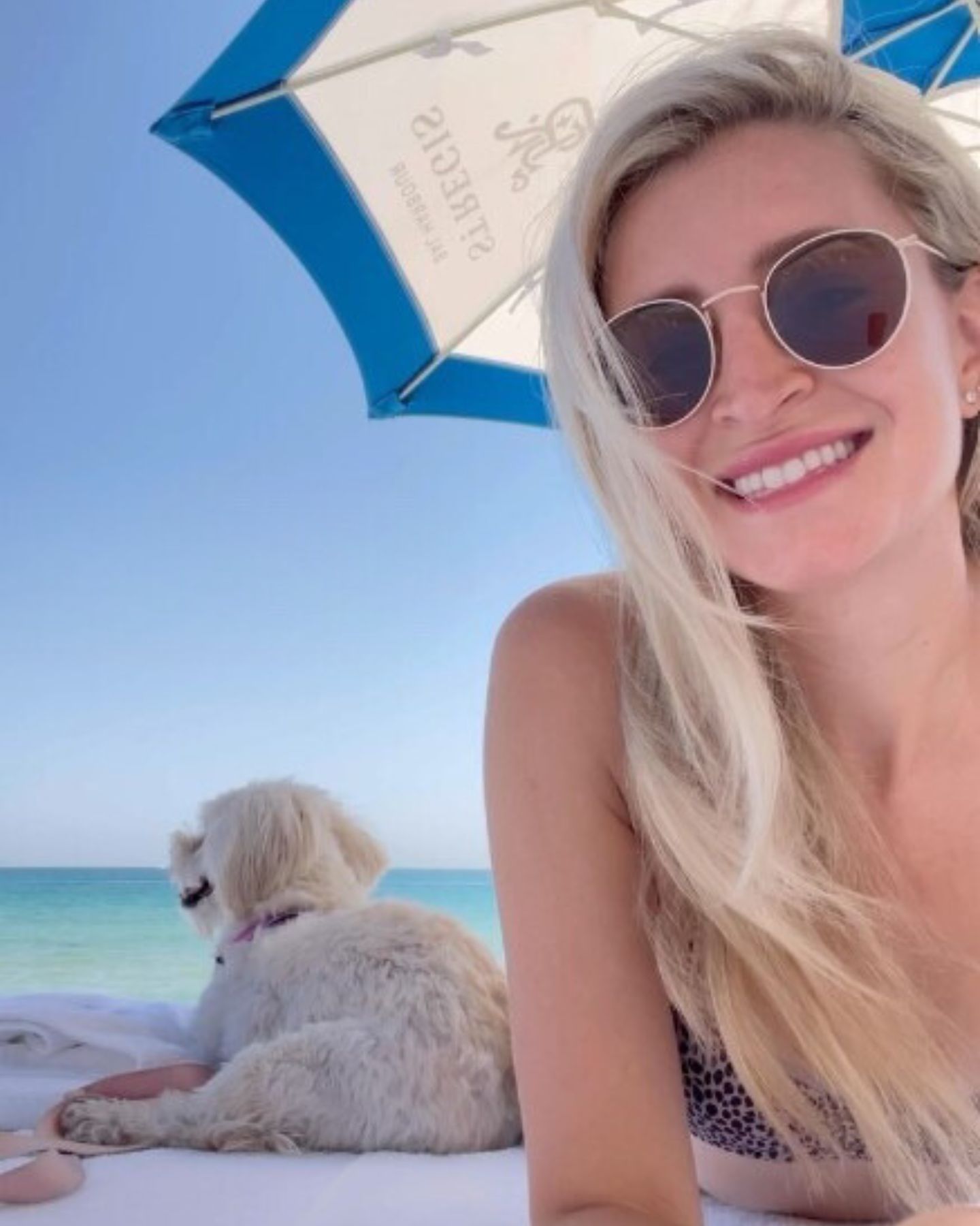 photo of woman and dog on the beach