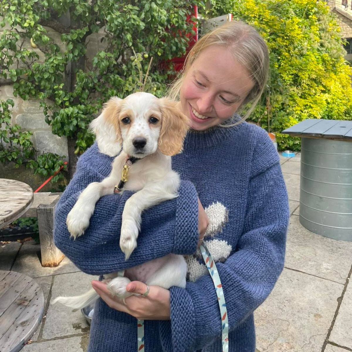 smiling woman holding a dog