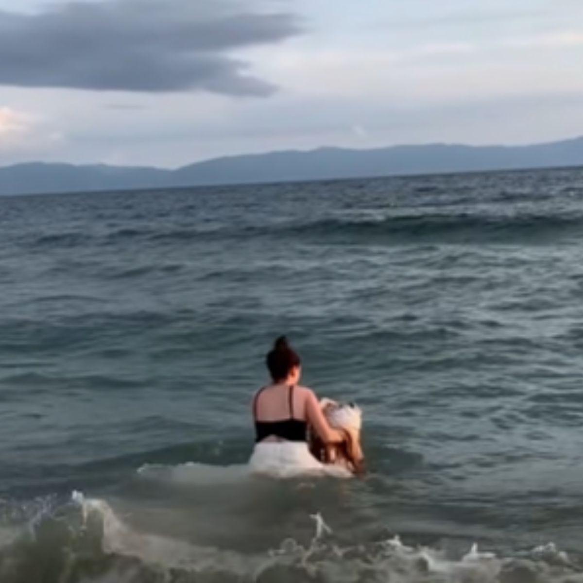 woman returning the fish in the ocean