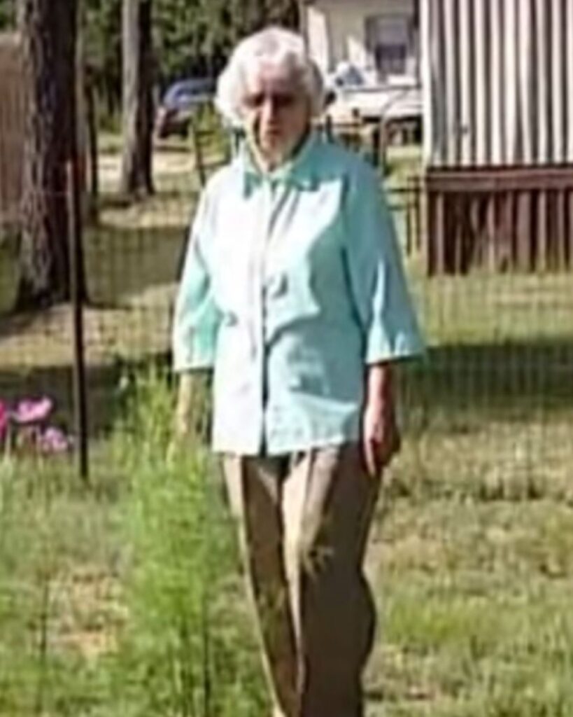 an elderly lady is walking in the park