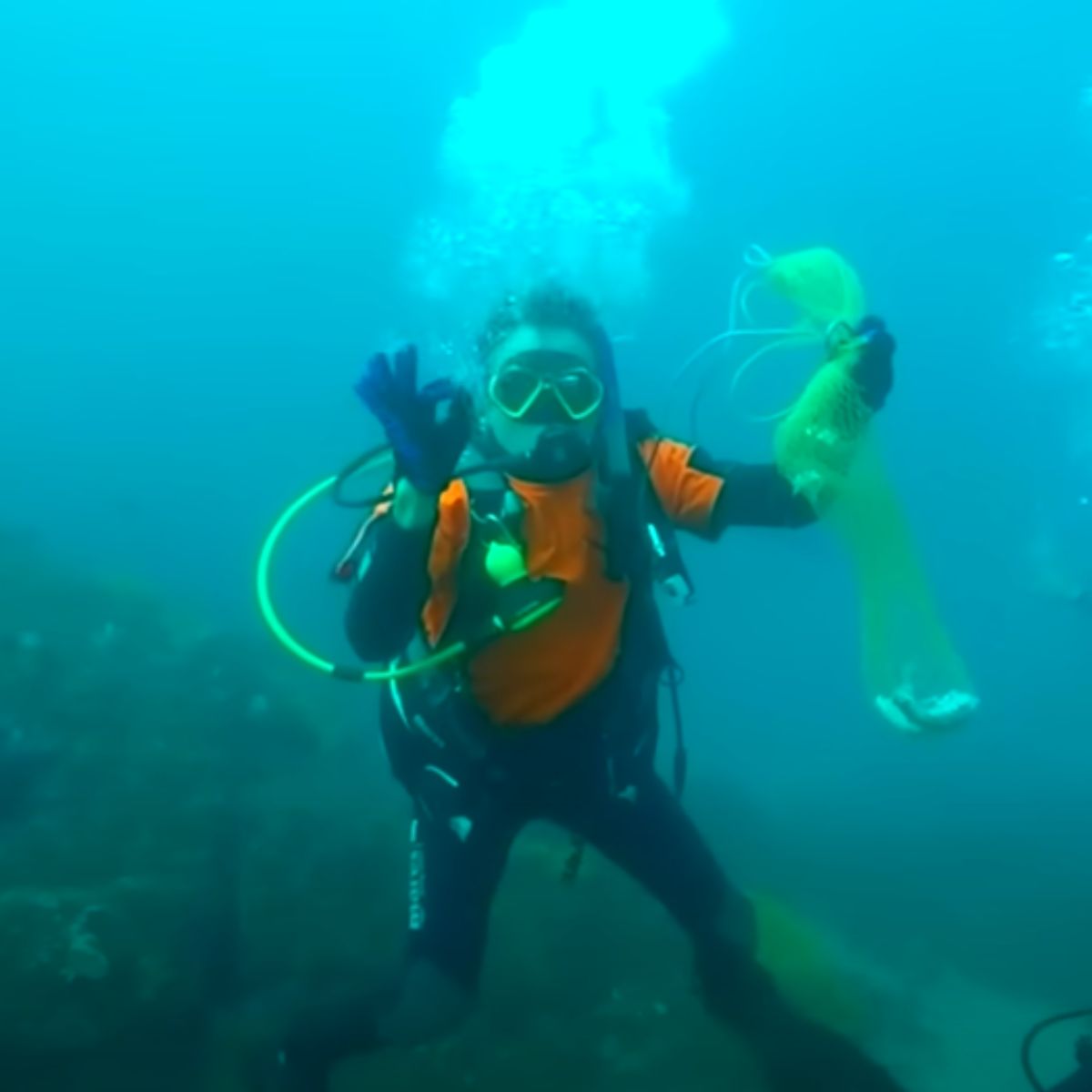 diver holding the fish net