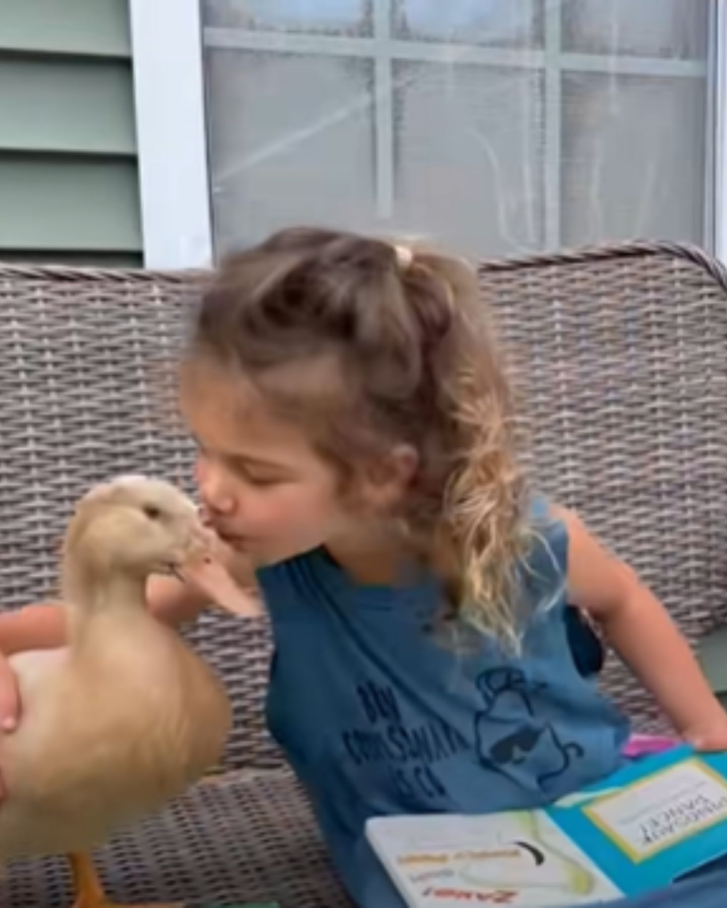 kid kissing a duck