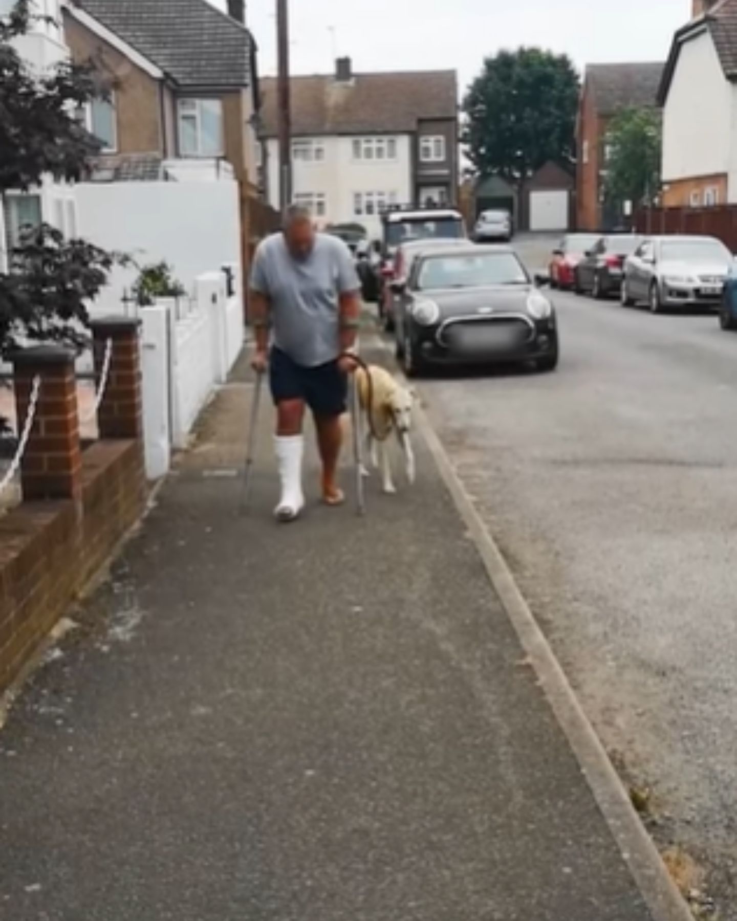 man and his dog limping on the street