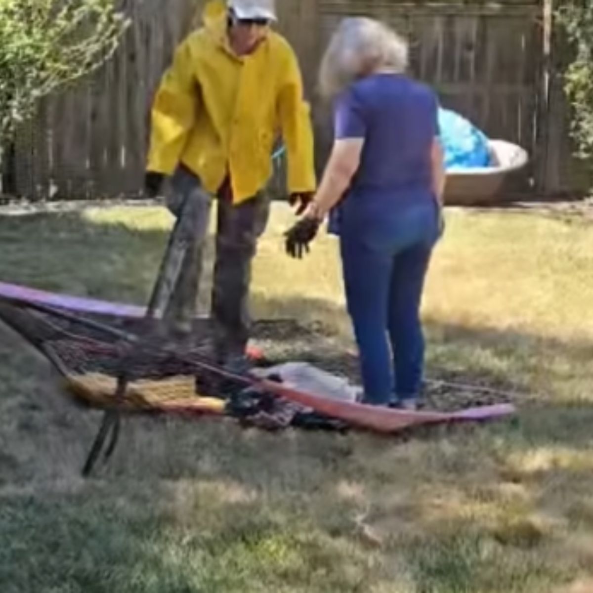 man and woman helping a skunk