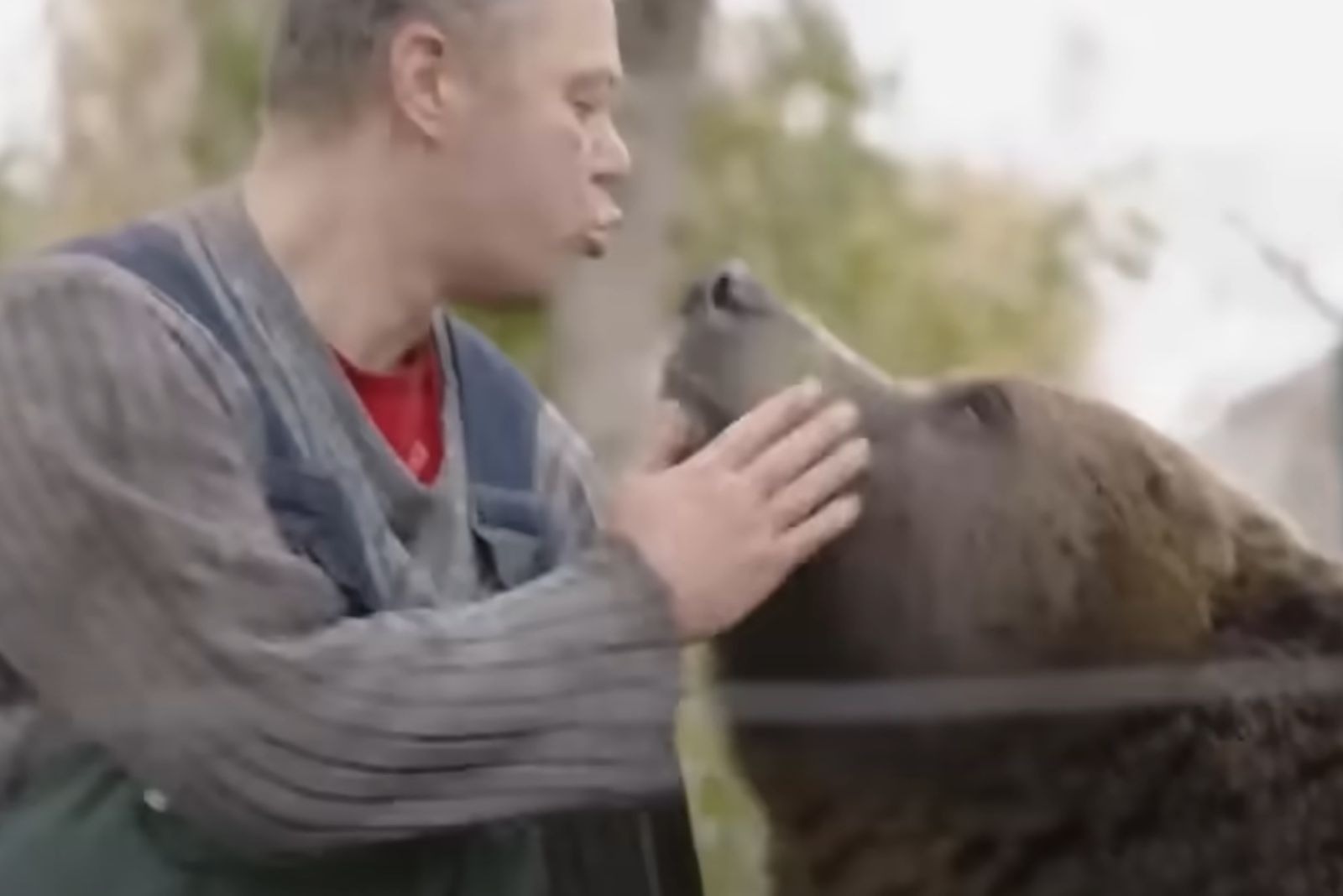 man kissing a bear