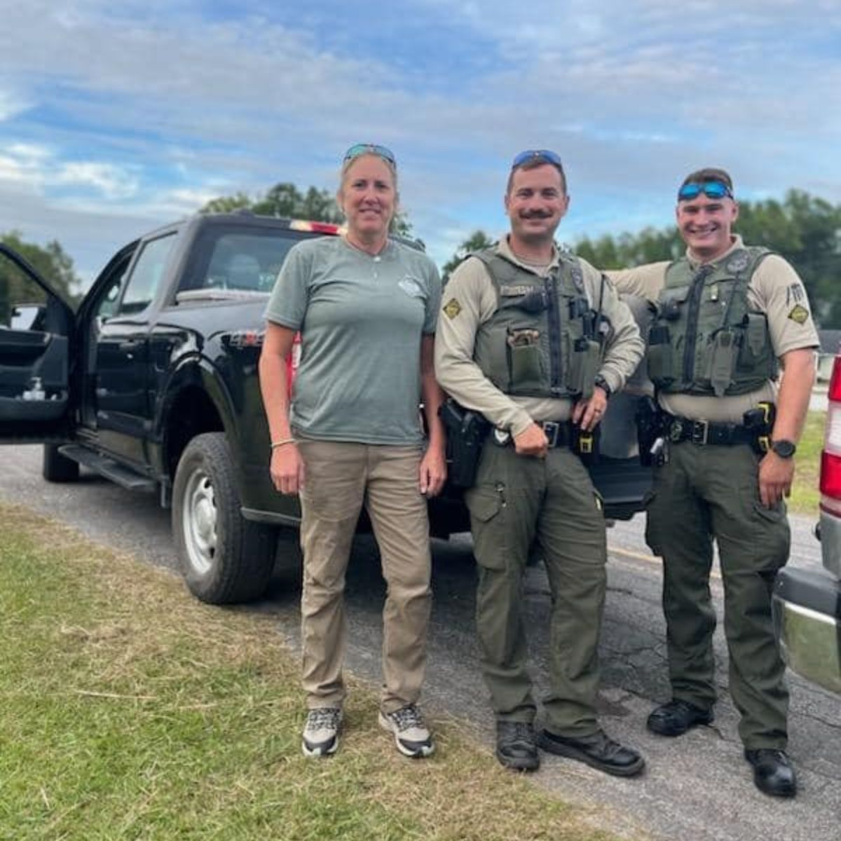 officers standing in front of a truck