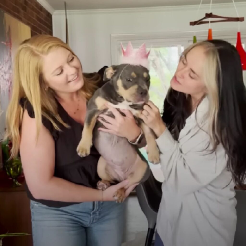 two girls celebrate their birthday with a dog