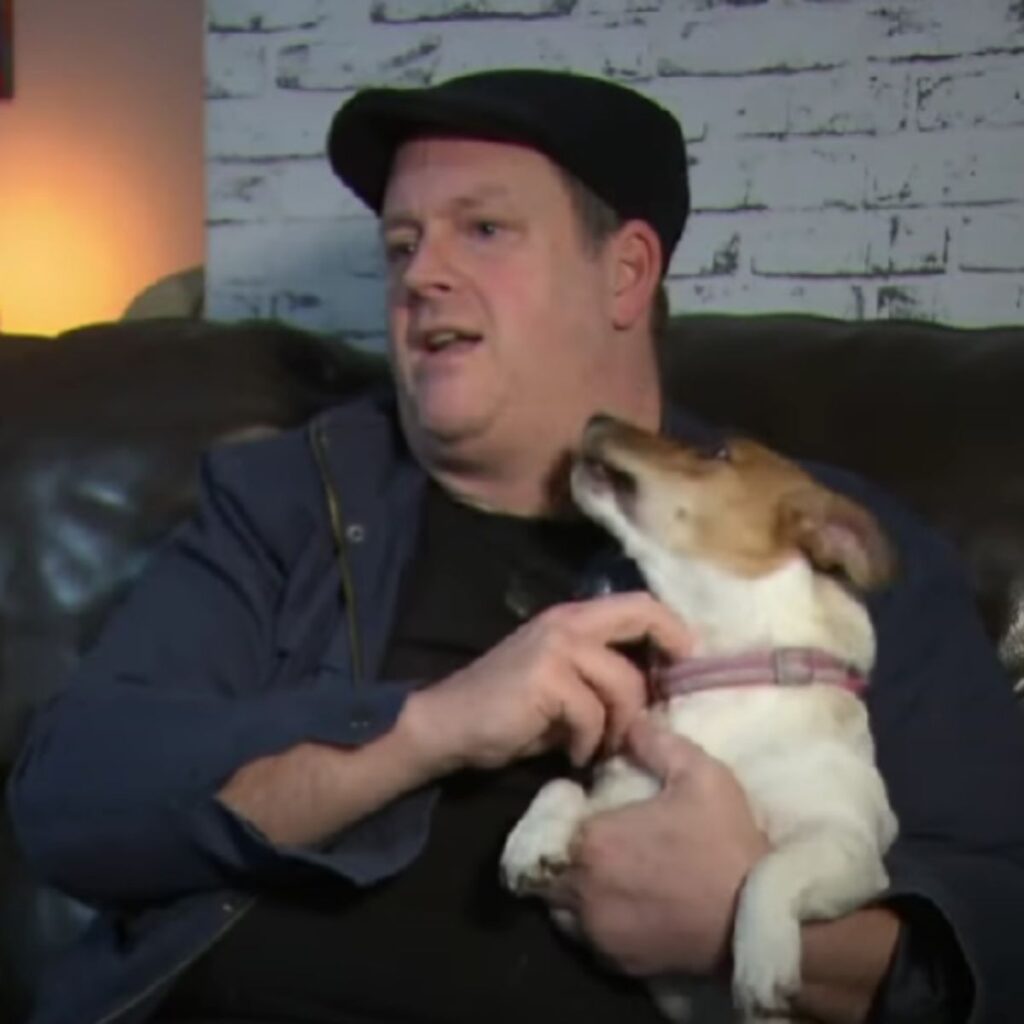 Jack Russell cuddling with a man