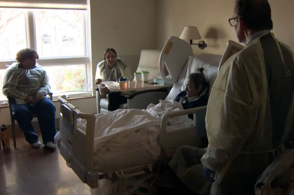 an old woman is lying in a hospital bed