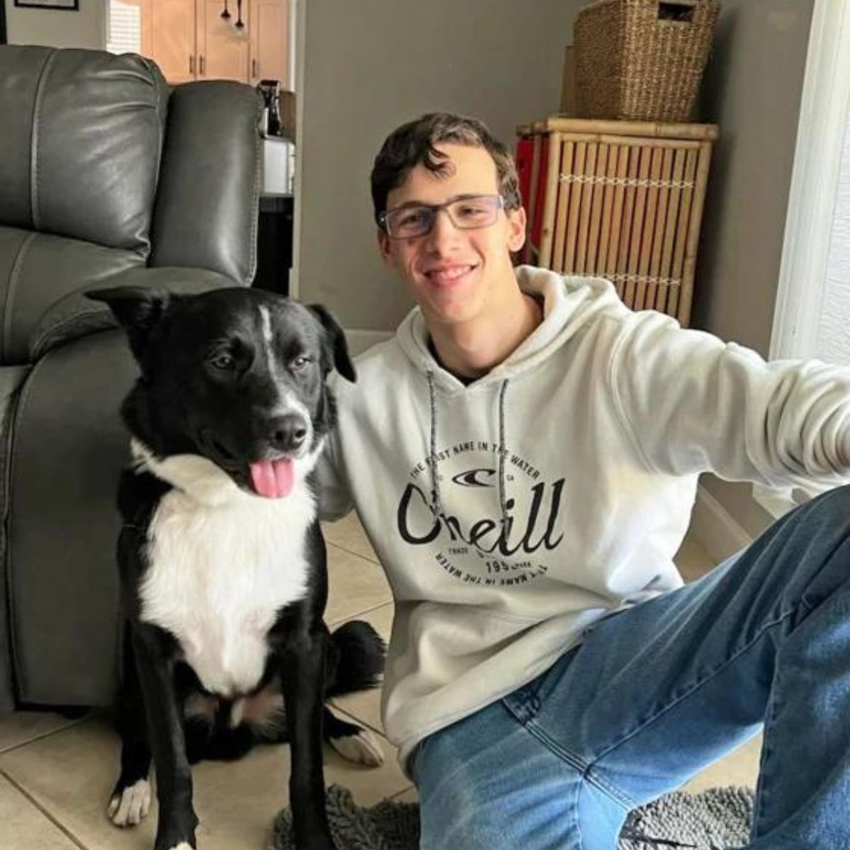 boy and dog sitting on the floor