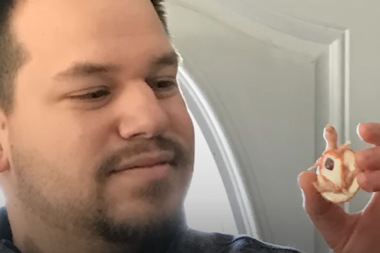 man holding a tiny turtle