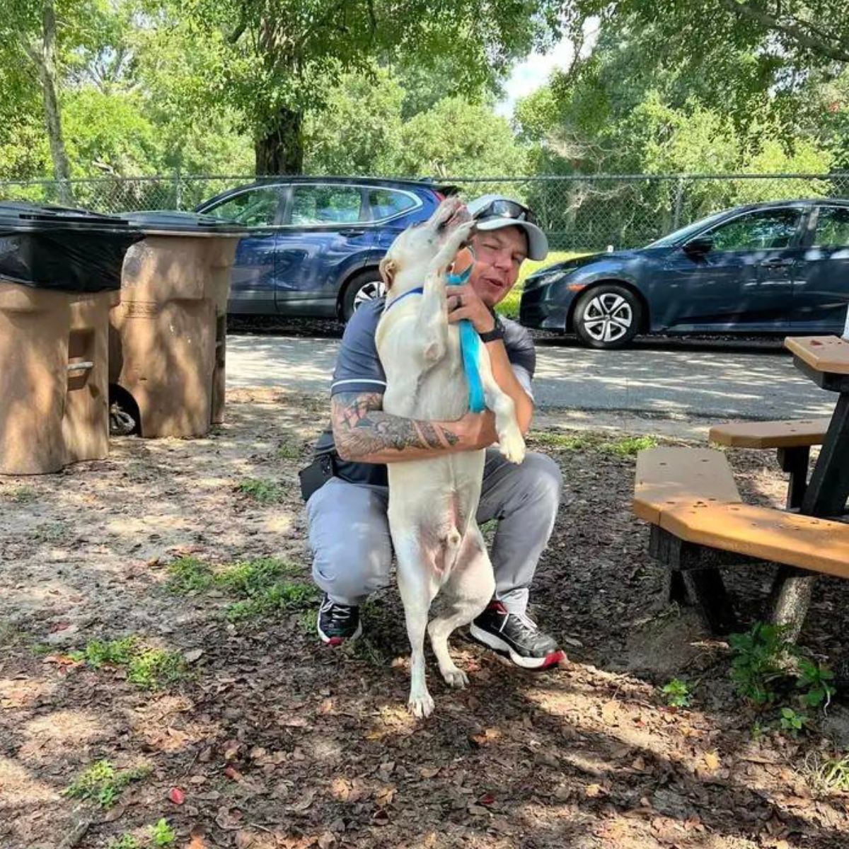 man hugging with happy dog