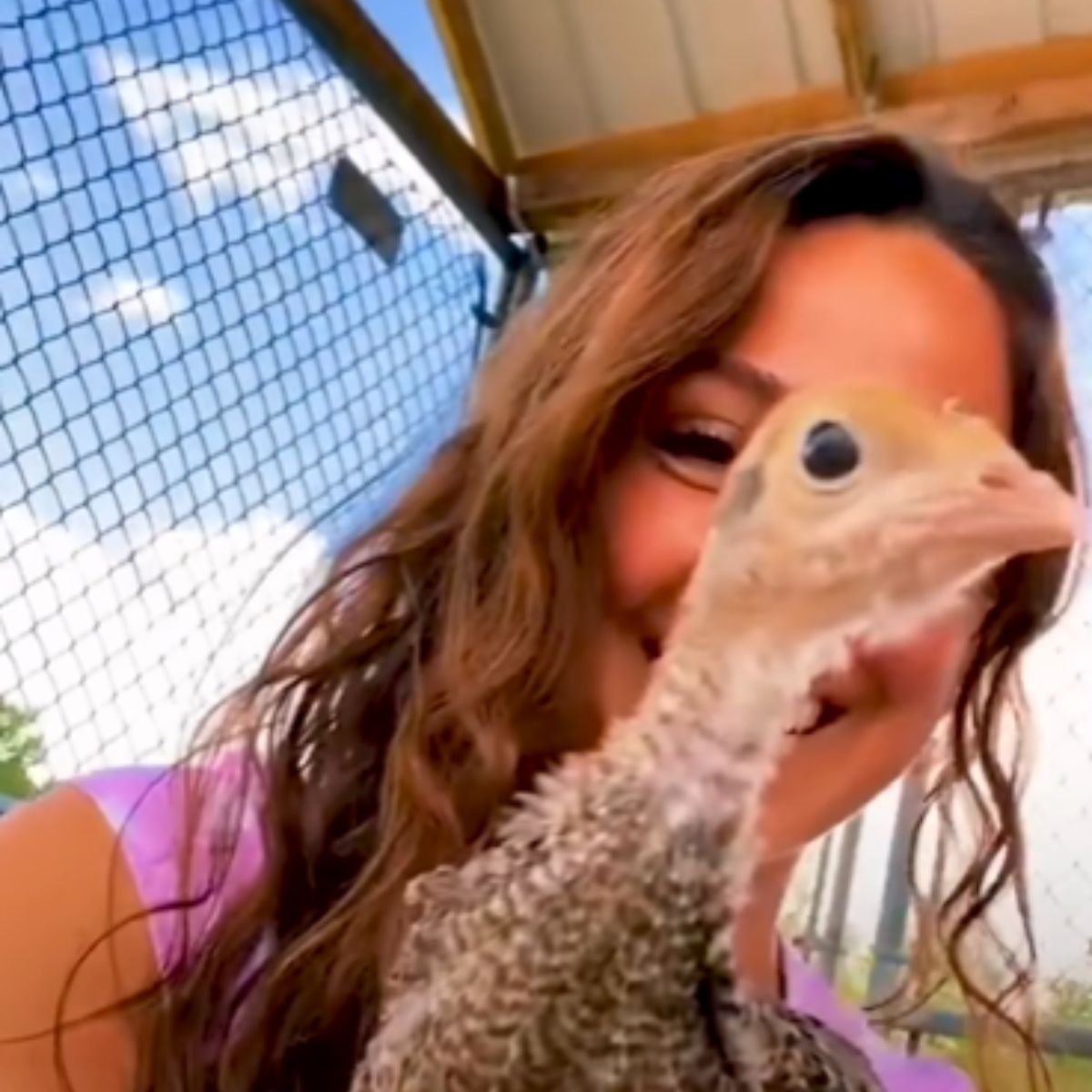 smiling woman with baby turkey