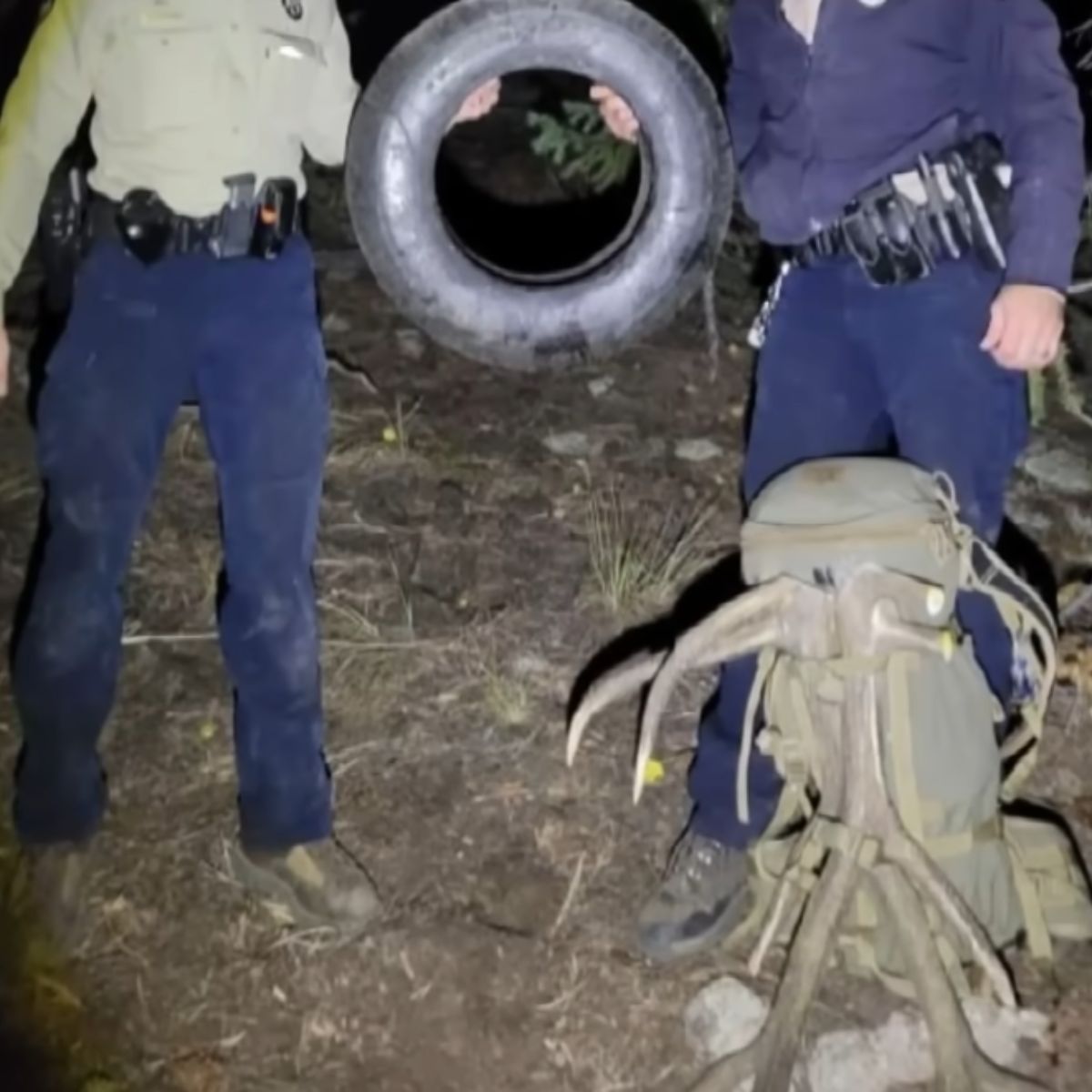 two men holding the tire