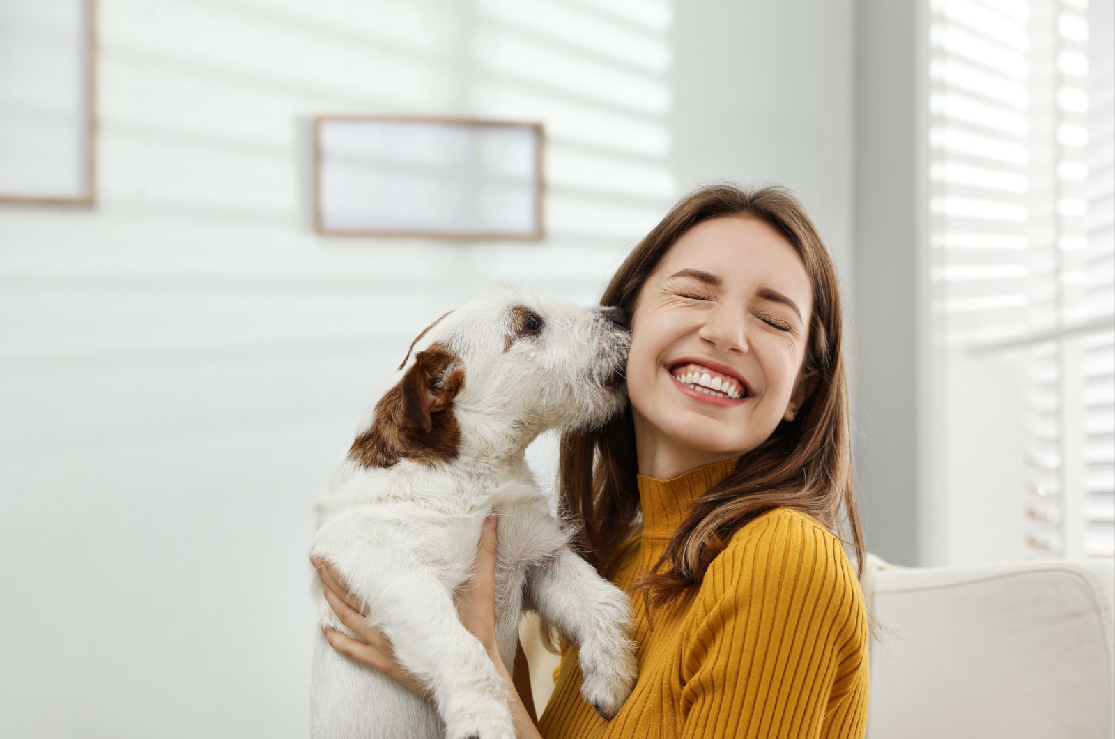 dog licking woman's face