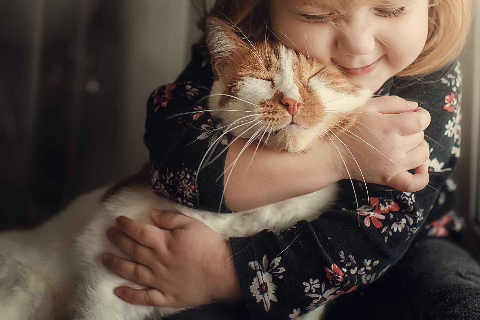 girl and cat hug