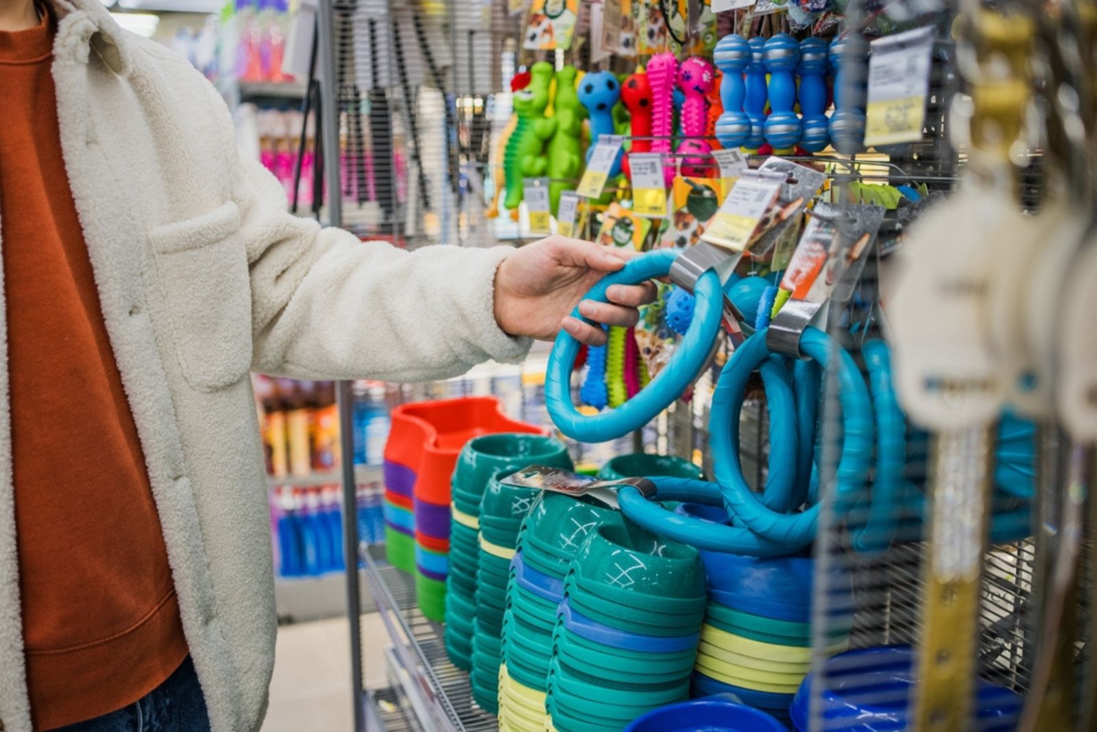 man picking a dog toy in store