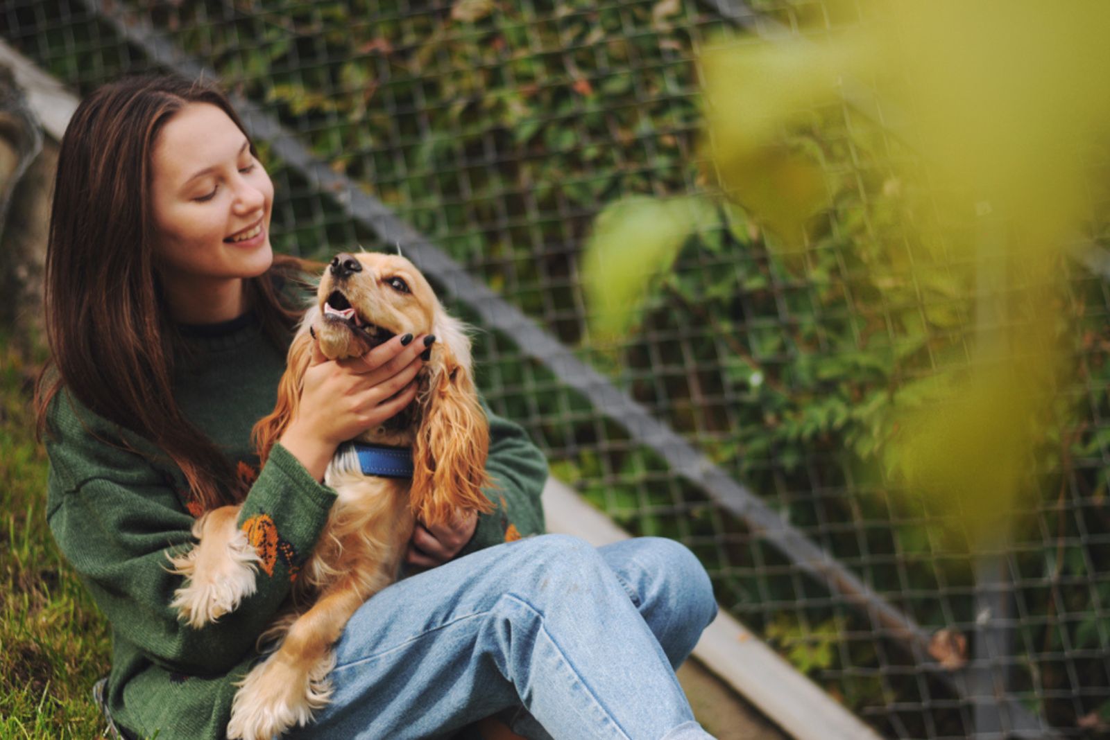 smiling woman holding her dog