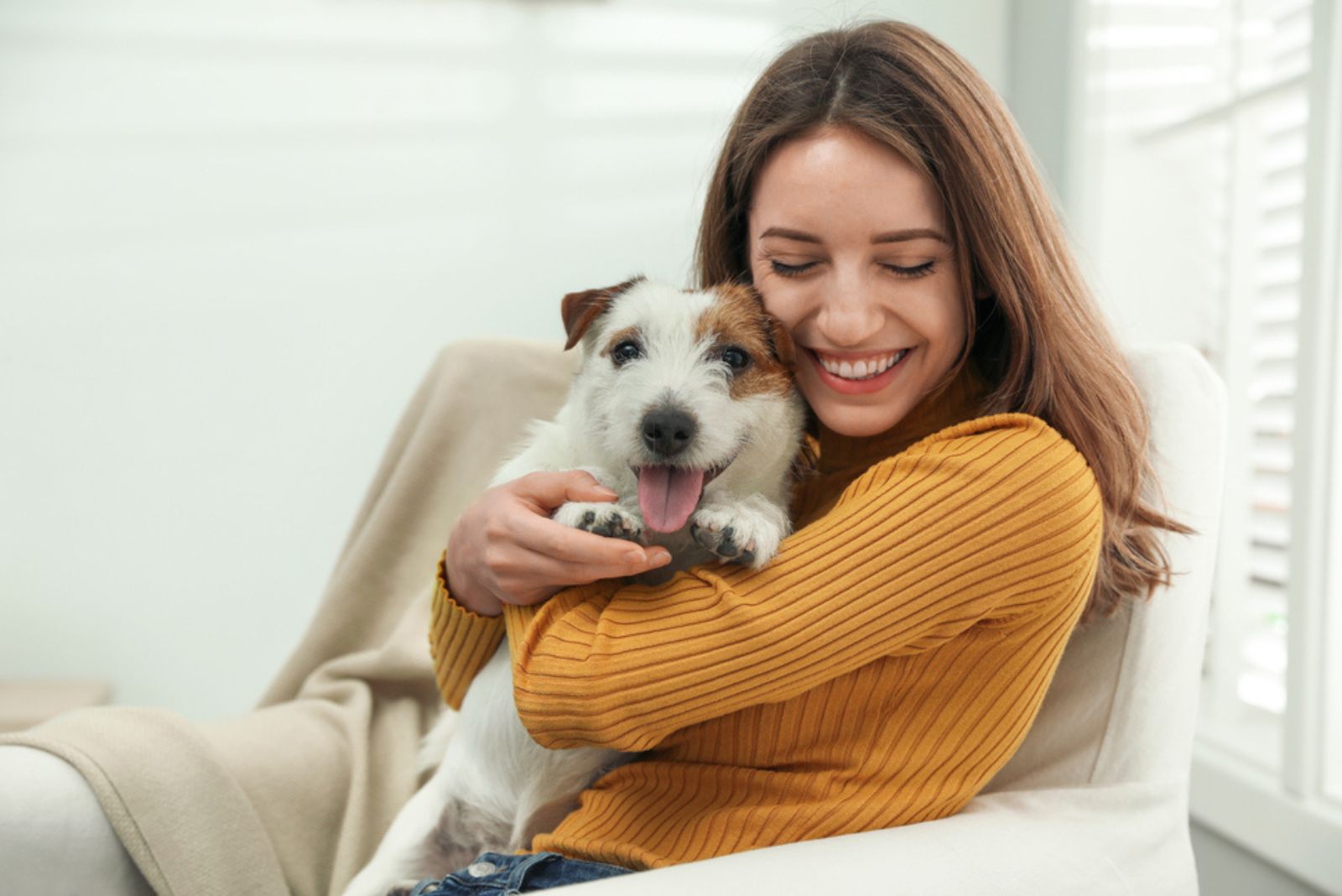 smiling woman hugging her dog