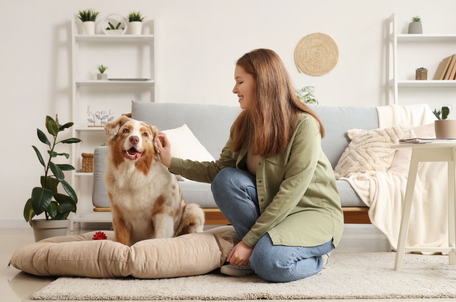 smiling woman with dog in the living room