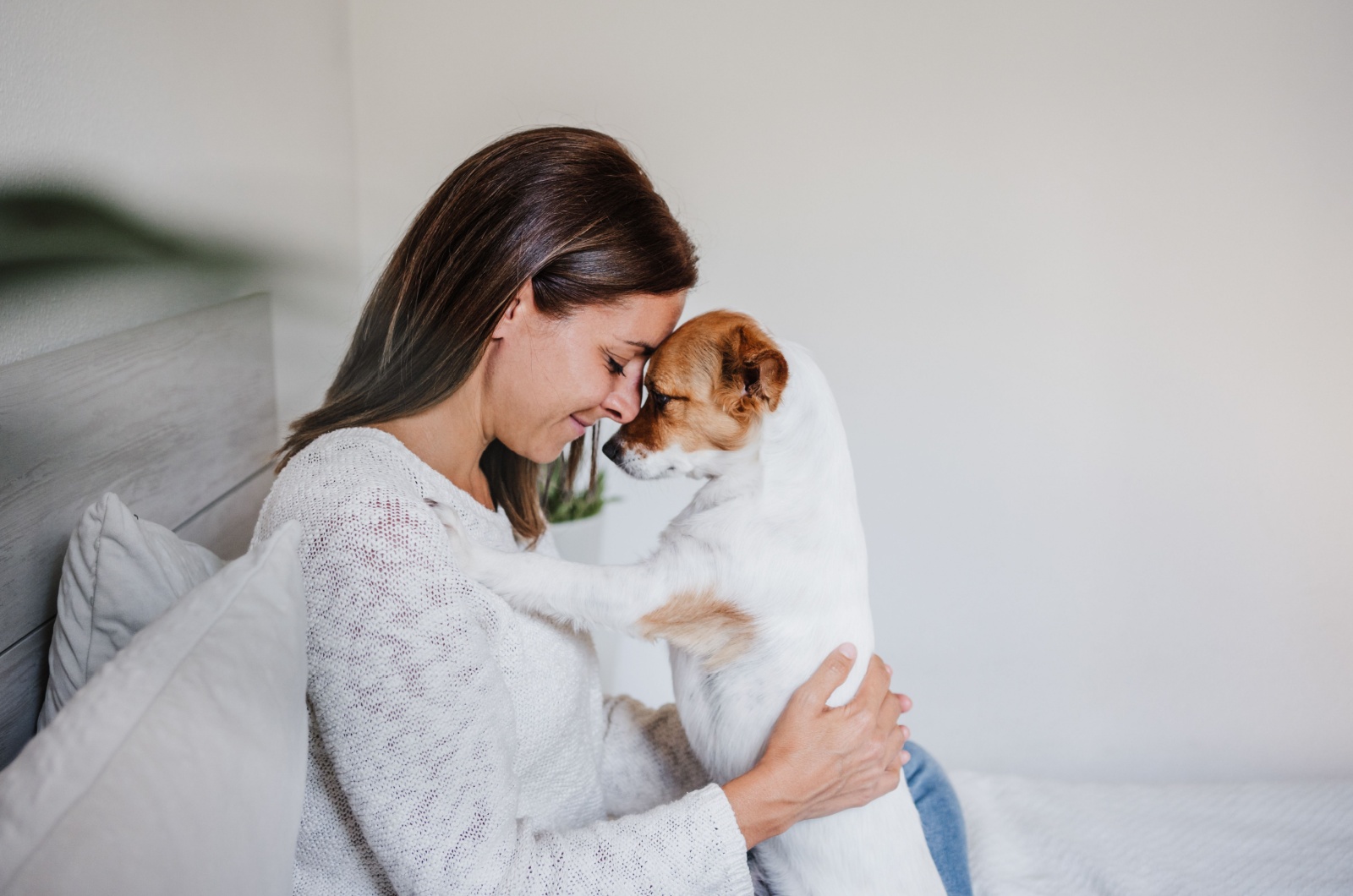 woman cuddling with a dog