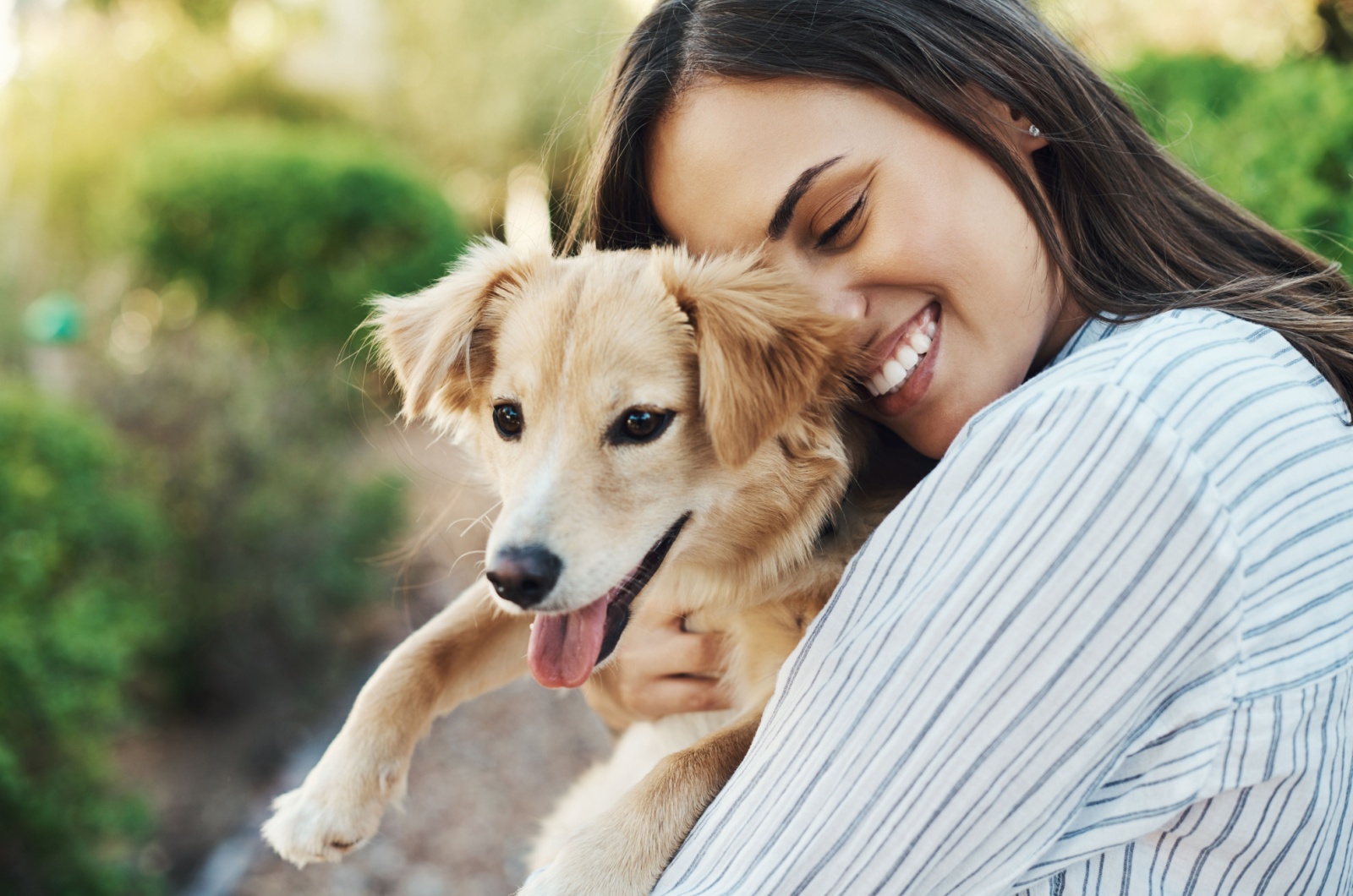 woman hugging a dog