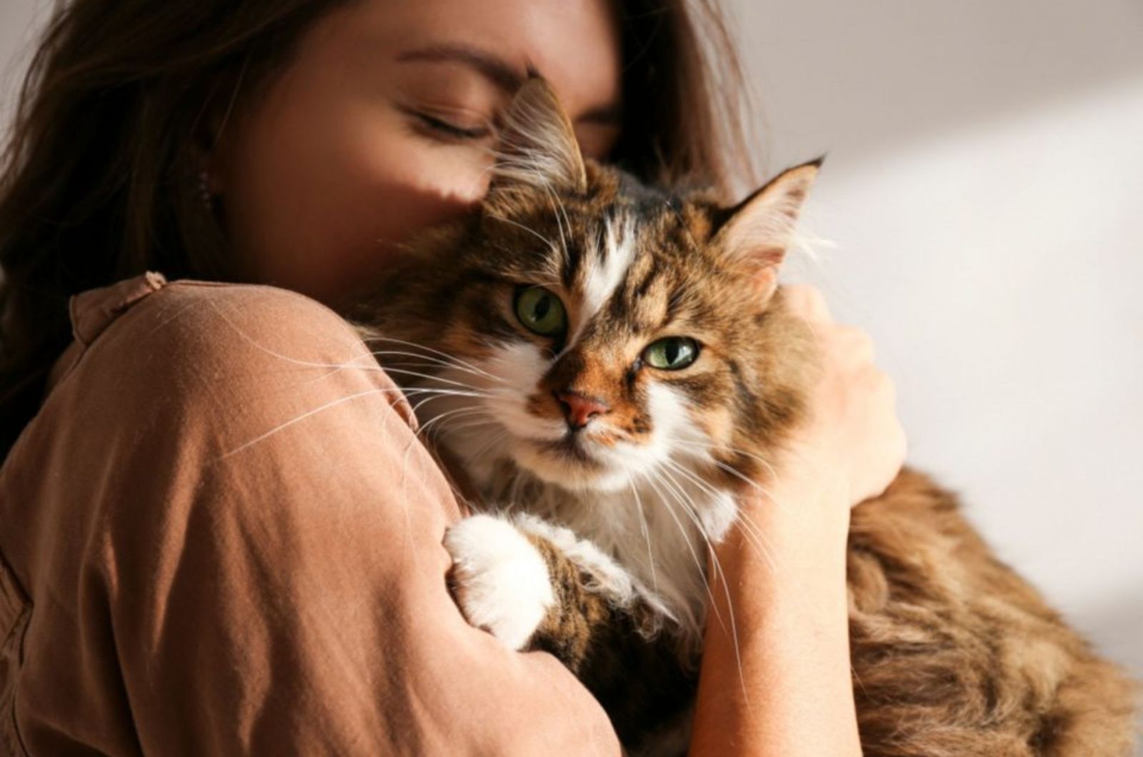 woman hugging cat