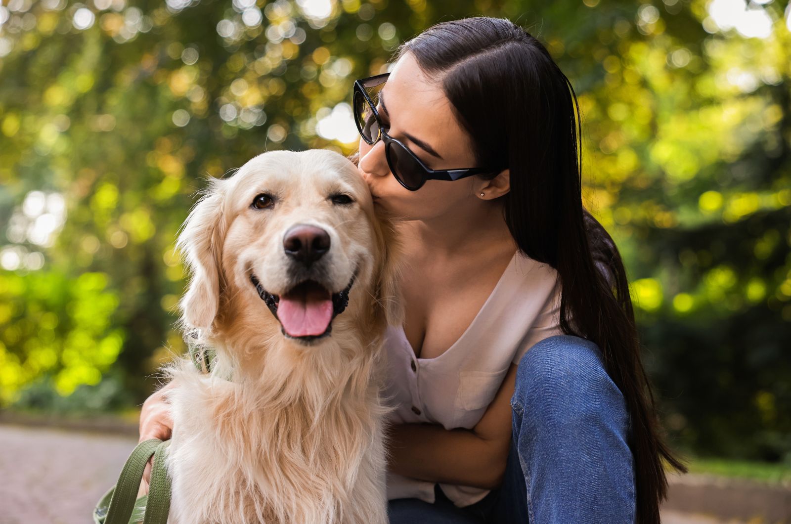 woman kissing dog