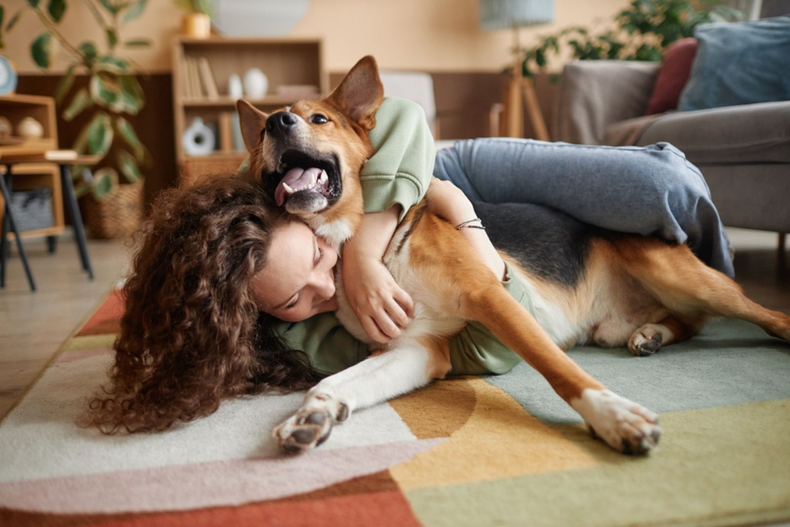 woman playing with dog