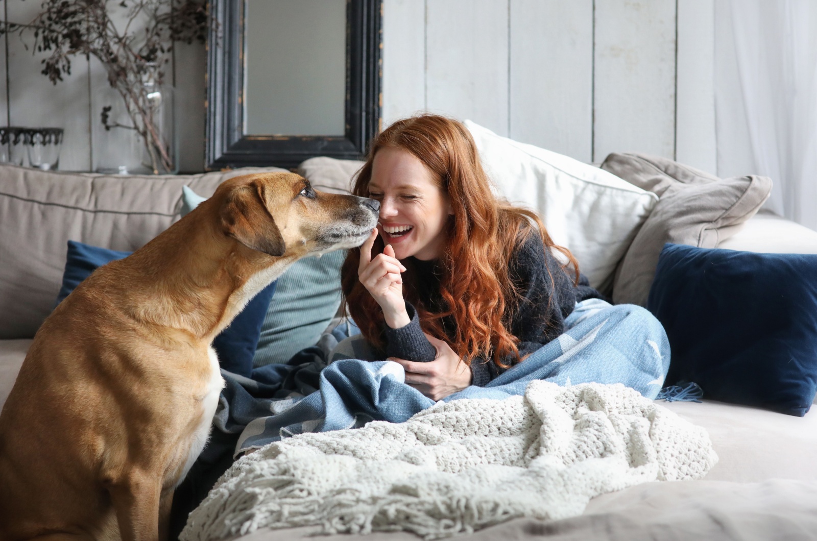 woman with dog laughing