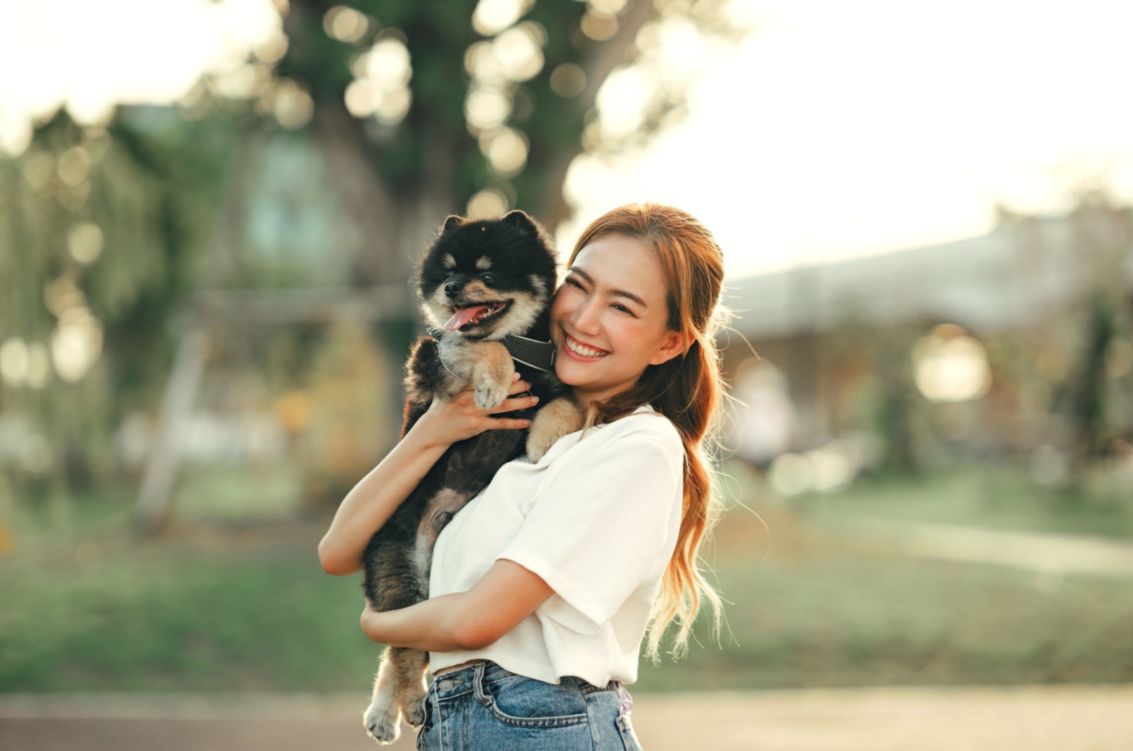 Happy woman hugging dog