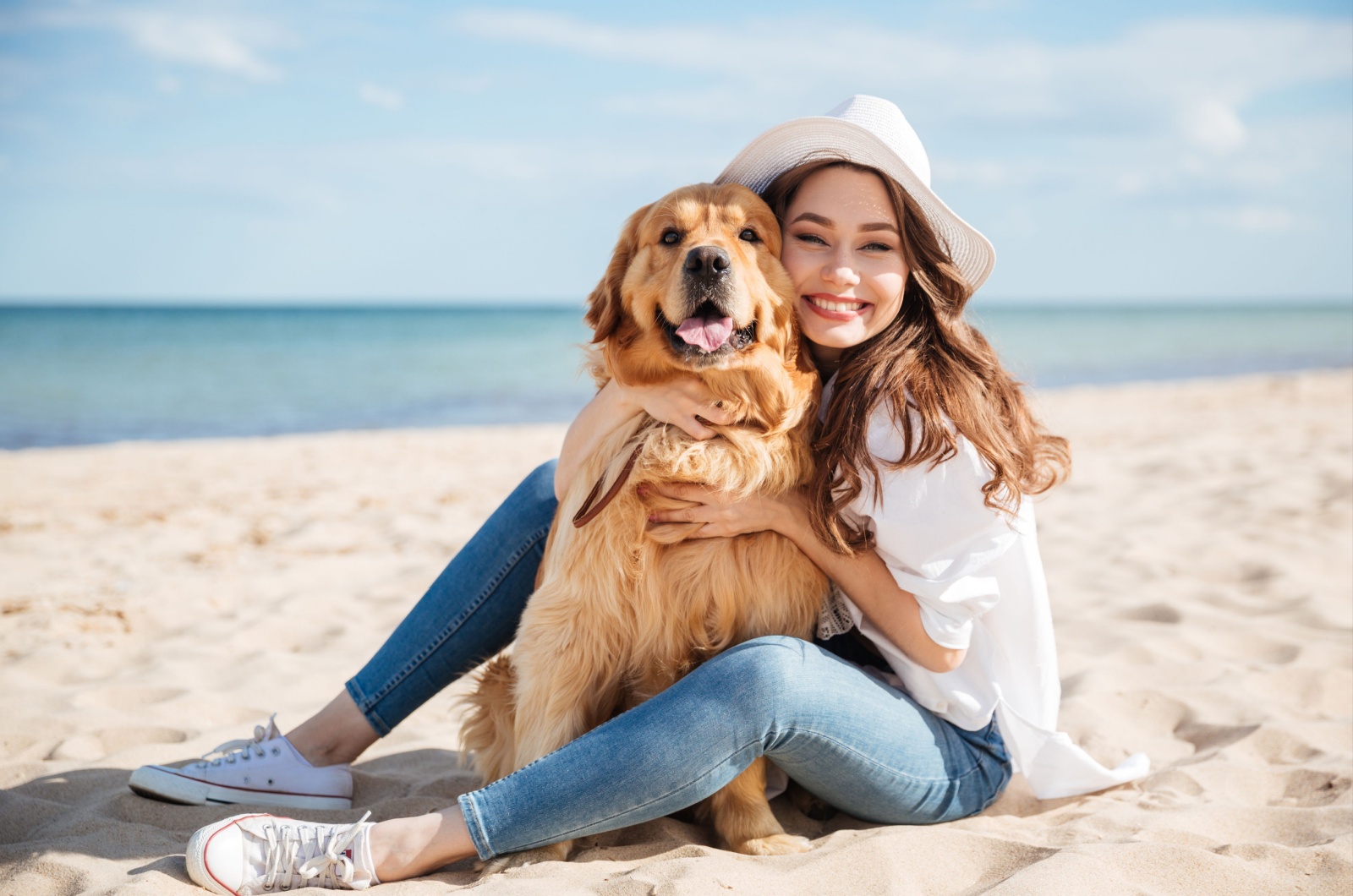 Woman and dog on beach