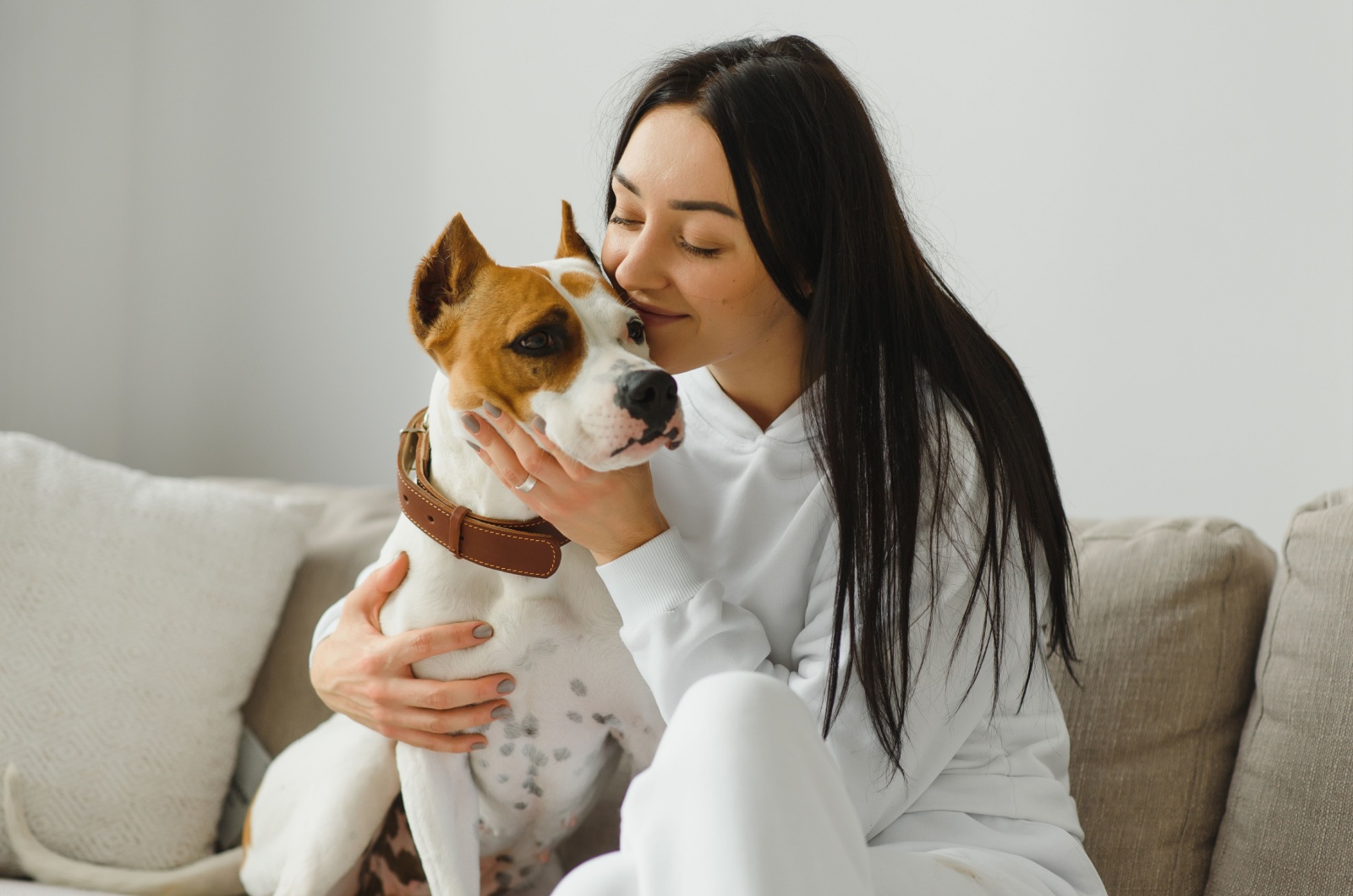 Woman kissing a dog