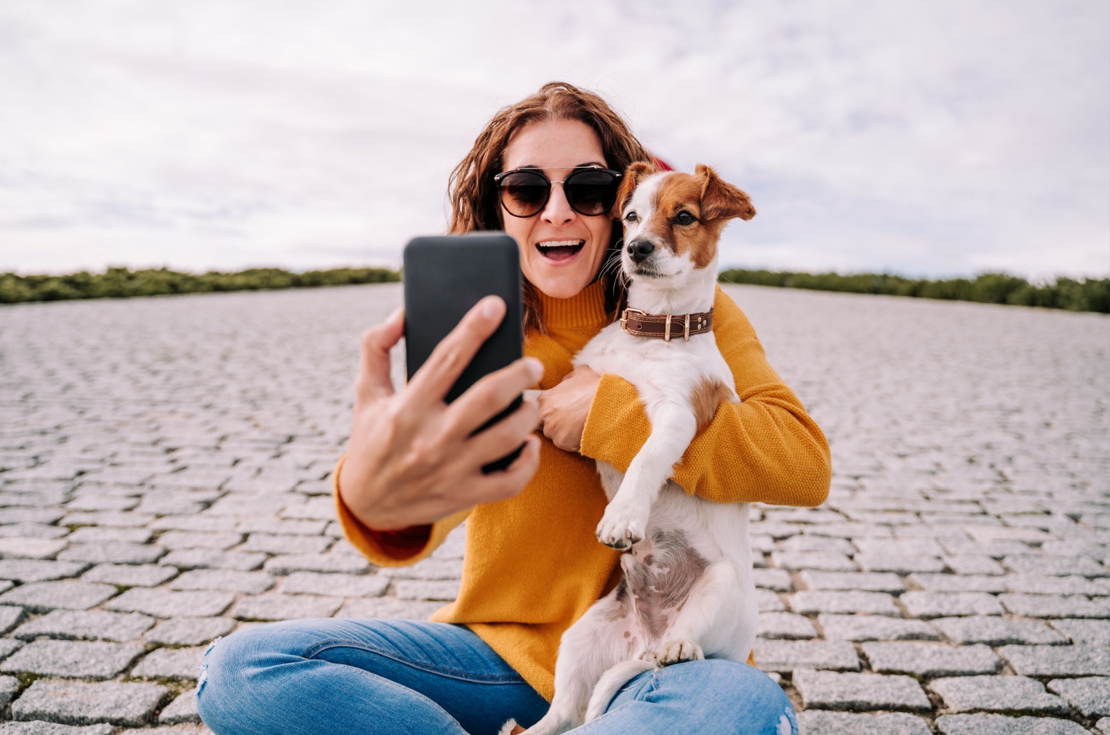 Woman taking a selfie with dog