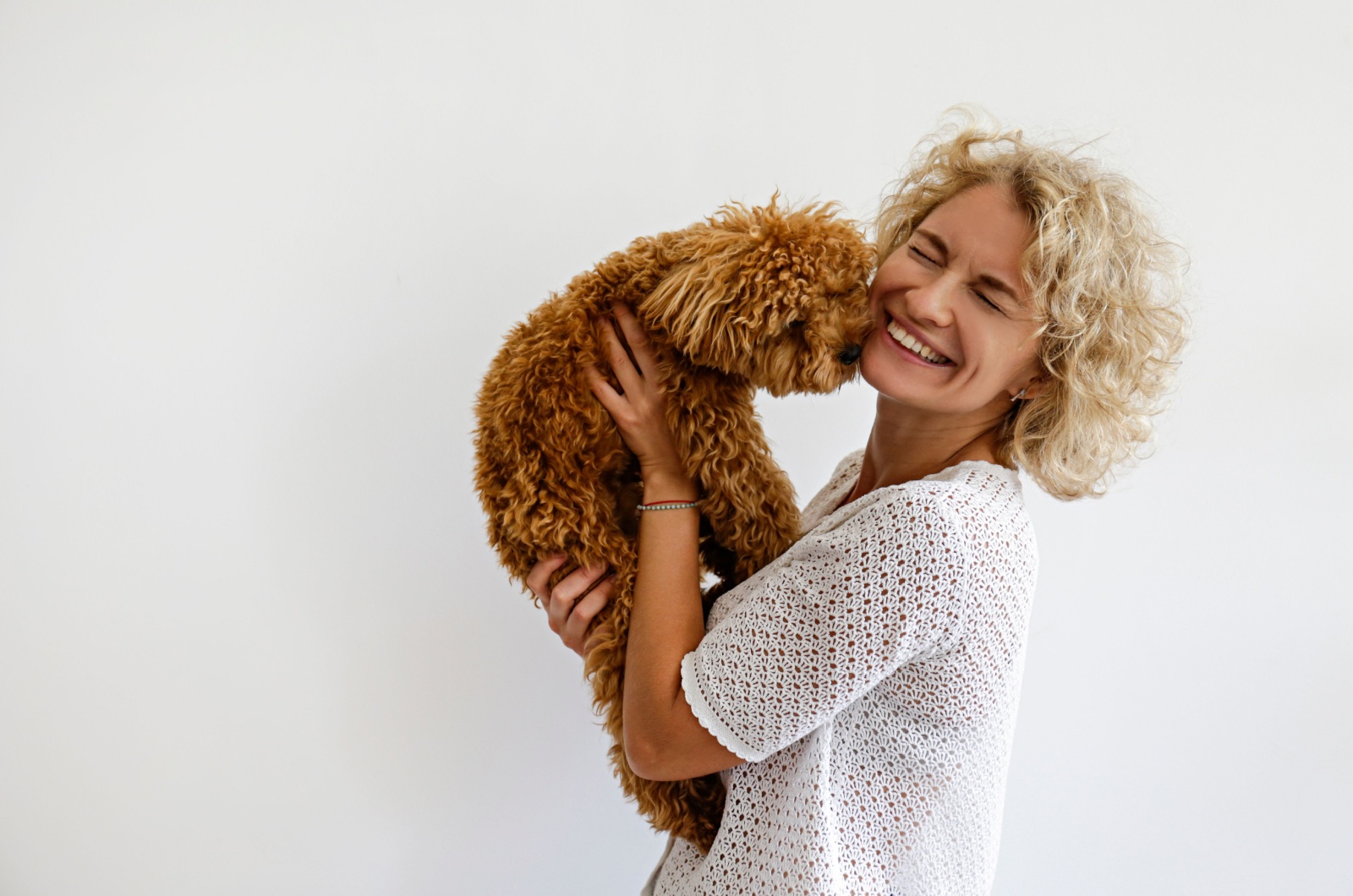 dog kissing an owner