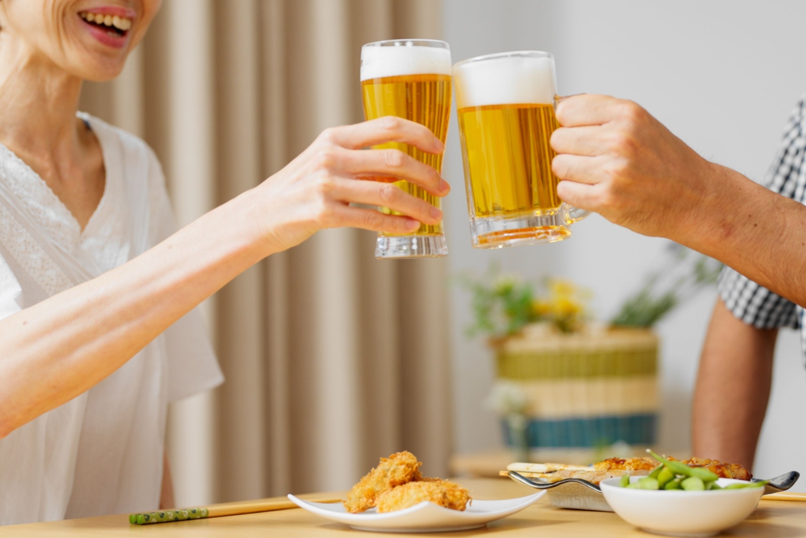 male and female holding beer