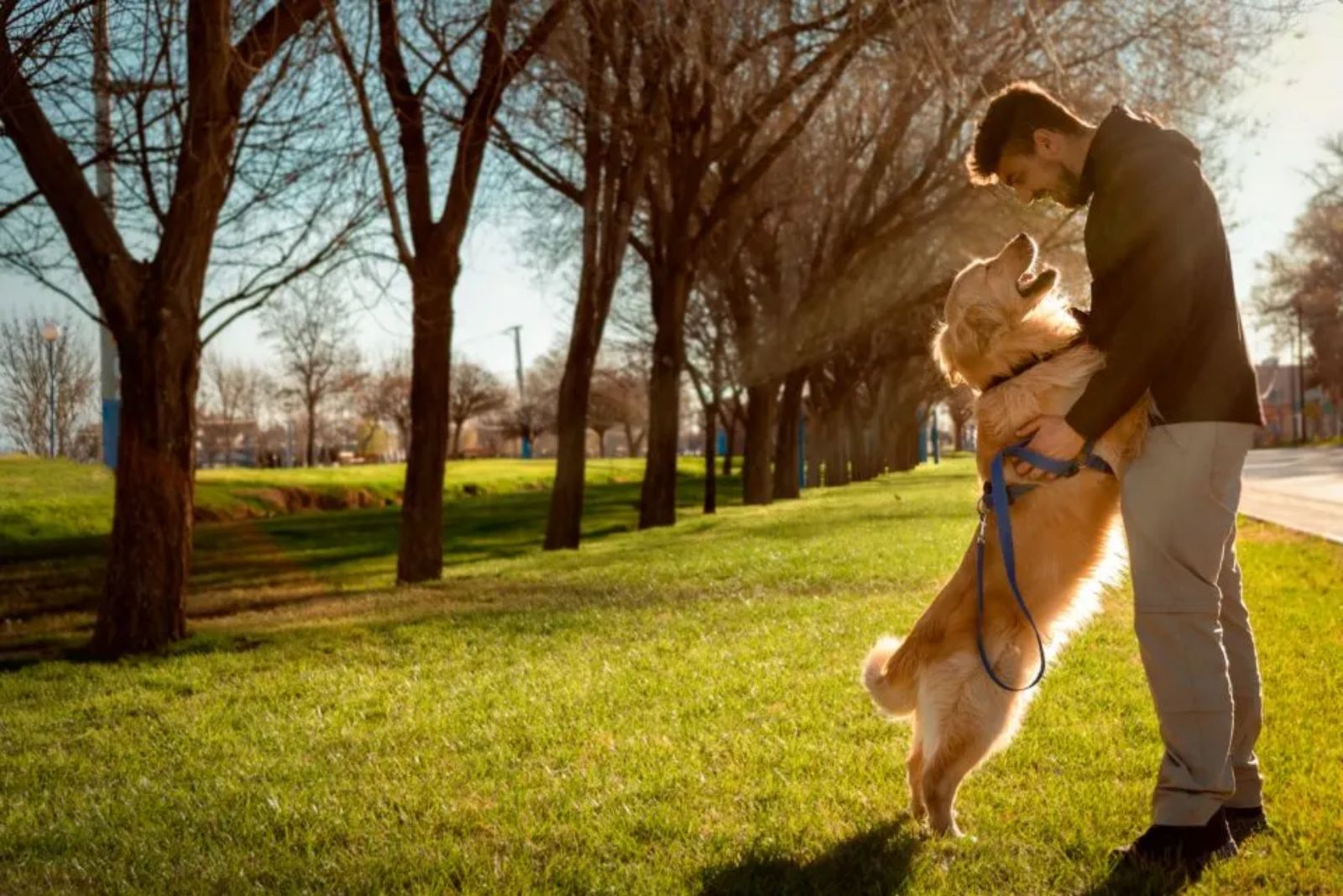 man hugging dog