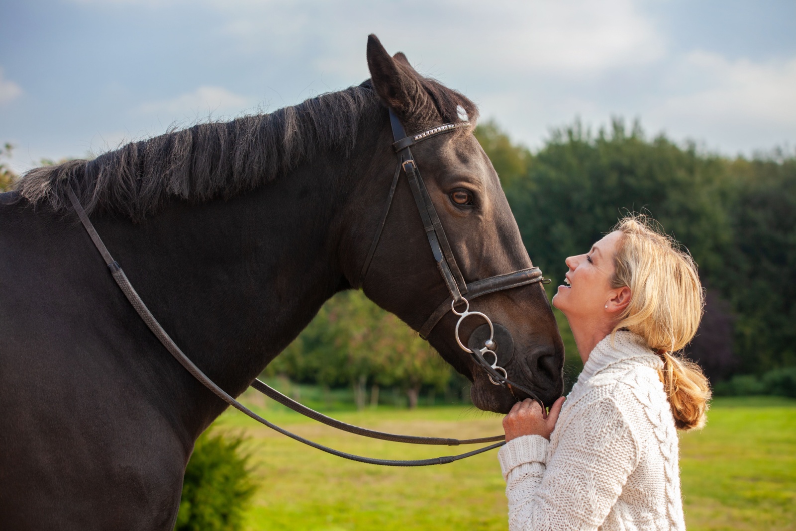 woman and horse facing each other