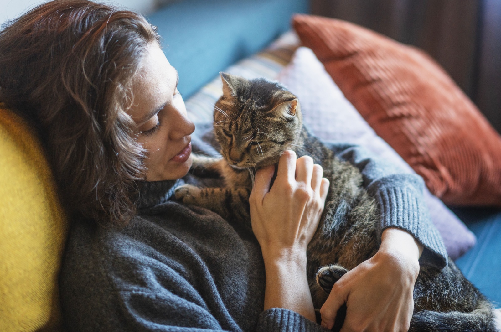 woman holding cat in arms